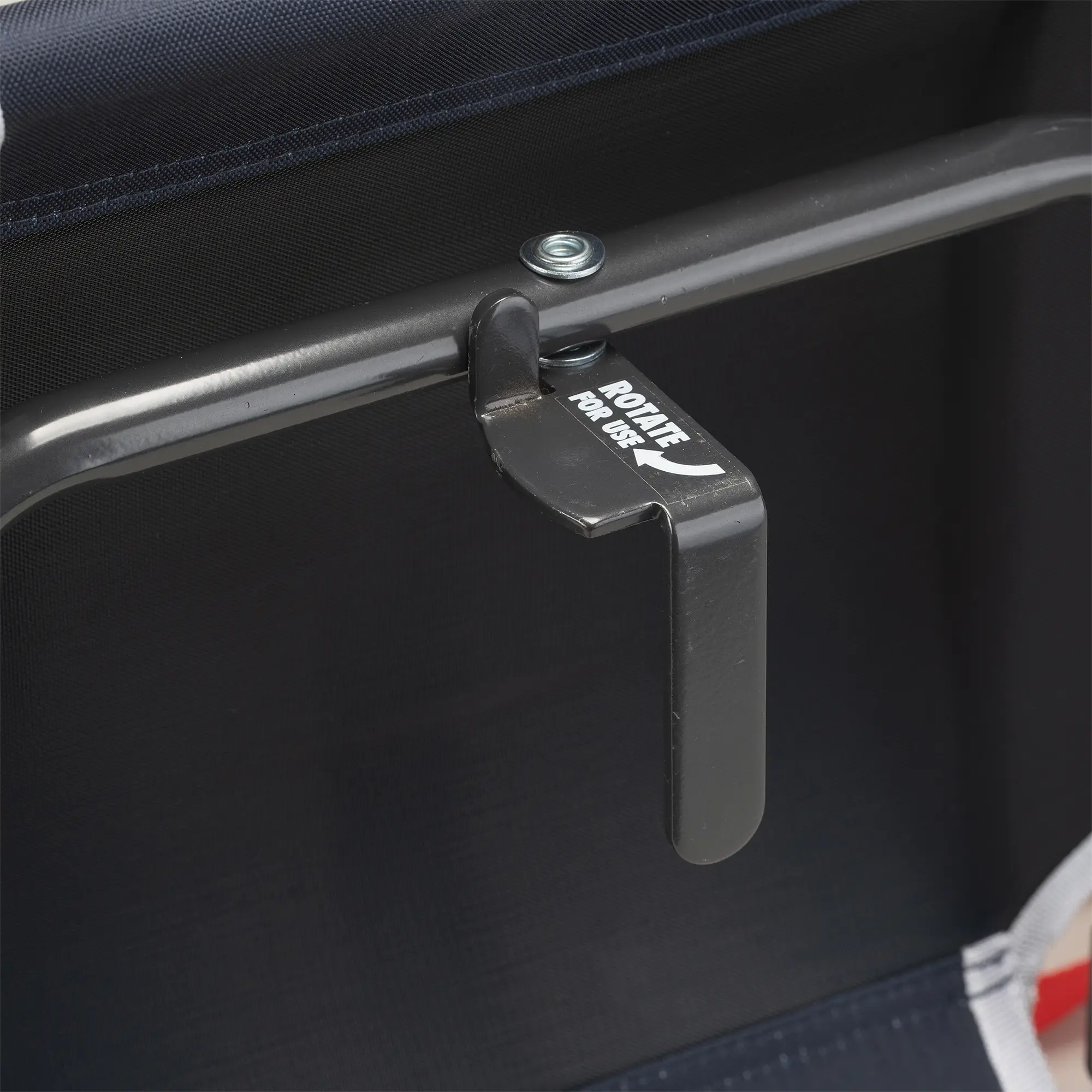 An up-close of the l-hook underneath the red/white/indigo big comfort stadium chair with armrests.