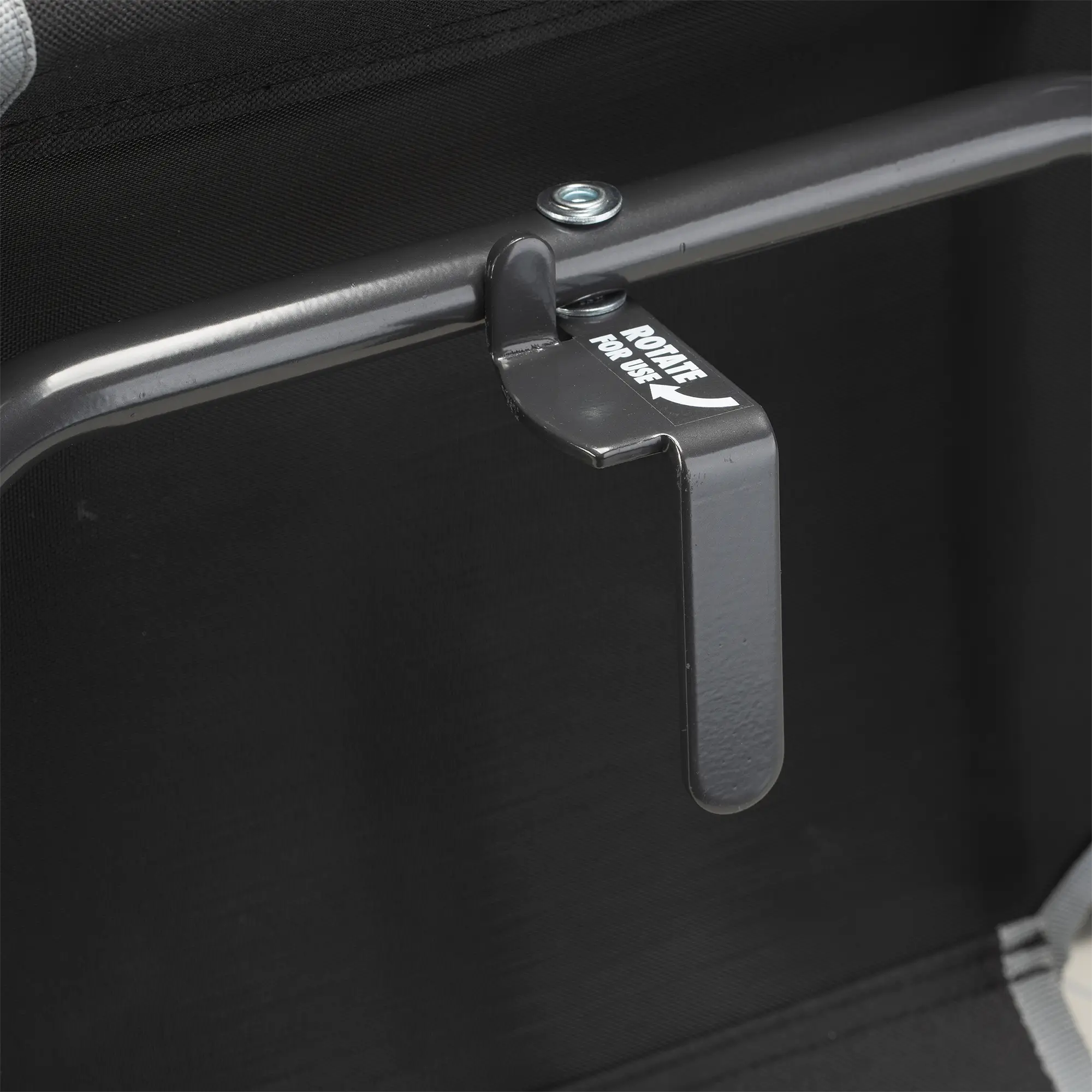 An up-close of the l-hook underneath the black/gray big comfort stadium chair with armrests.