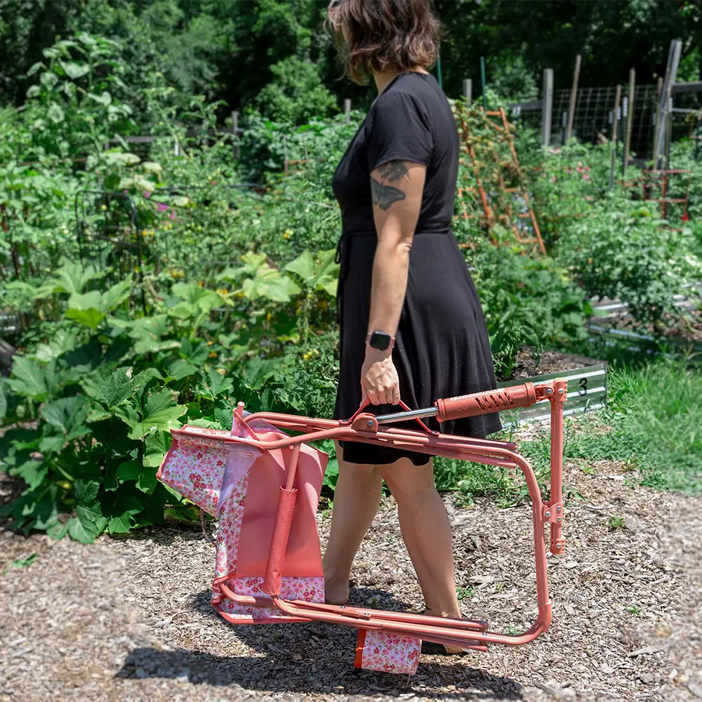 A woman carrying a pink sundress freestyle rocker elite with the integrated carry handle.