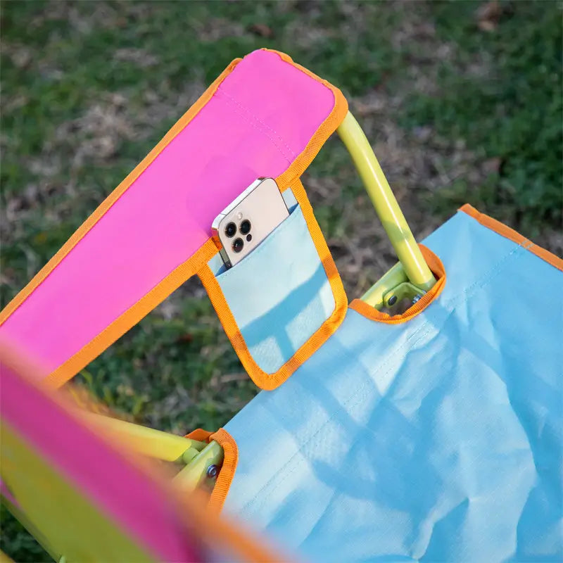 Sweet Tea Comfort Pro Rocker armrest with phone pocket and bright trim in pink, orange, and aqua blue.