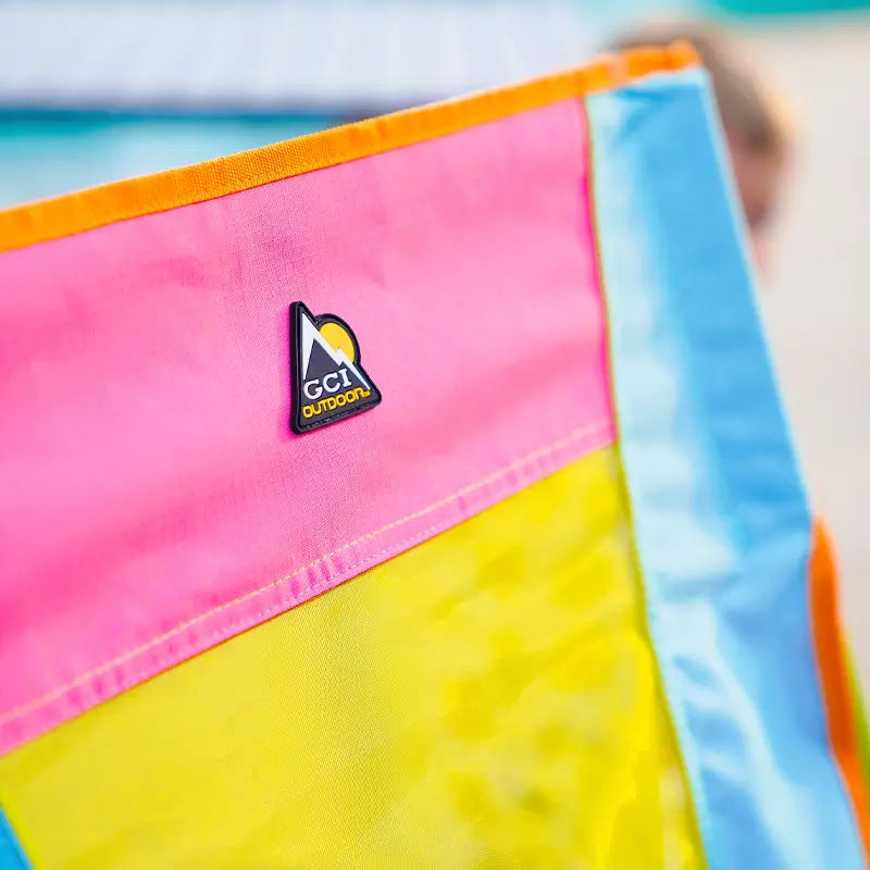 Close-up of GCI Outdoor logo on the back of the Sweet Tea Comfort Pro Rocker in bold, vibrant colors.
